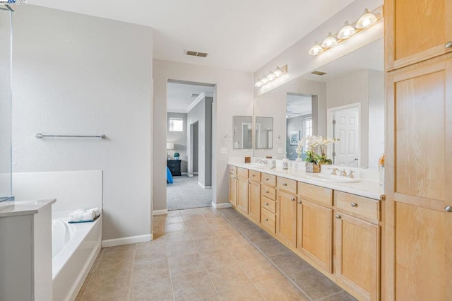 bathroom with vanity, tile patterned floors, and a bathing tub