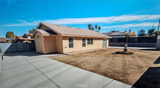 rear view of property featuring a patio