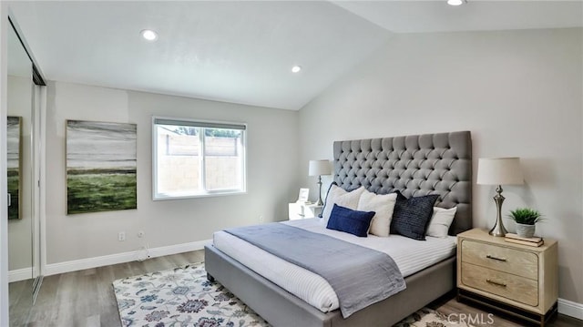 bedroom featuring dark hardwood / wood-style floors and vaulted ceiling