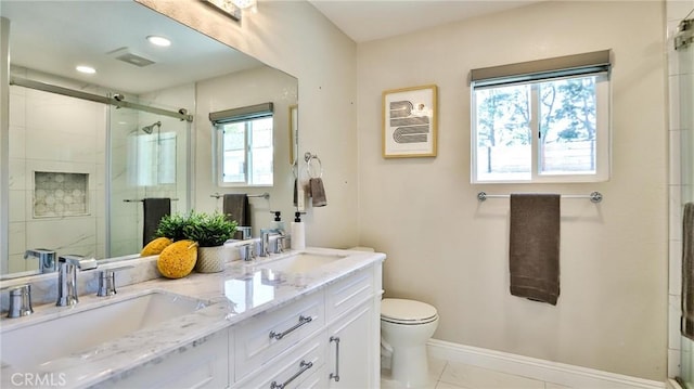 bathroom with vanity, toilet, tile patterned flooring, and a shower with door