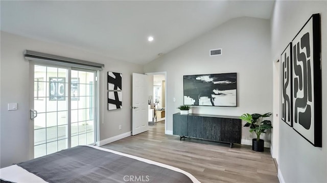 bedroom featuring lofted ceiling and light hardwood / wood-style flooring