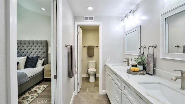 bathroom featuring vanity, toilet, and tile patterned flooring