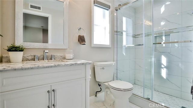 bathroom with vanity, toilet, and an enclosed shower