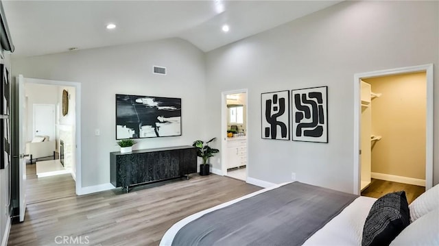 bedroom featuring lofted ceiling and hardwood / wood-style floors