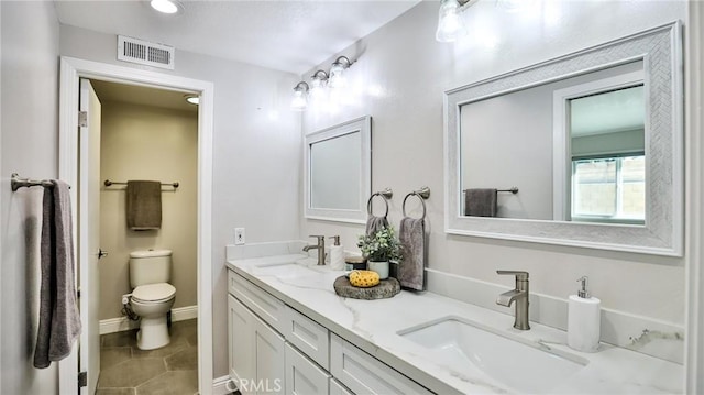 bathroom with tile patterned floors, vanity, and toilet