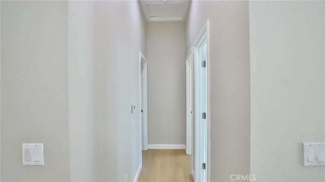 hallway with light hardwood / wood-style flooring