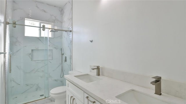 bathroom featuring vanity, an enclosed shower, and toilet