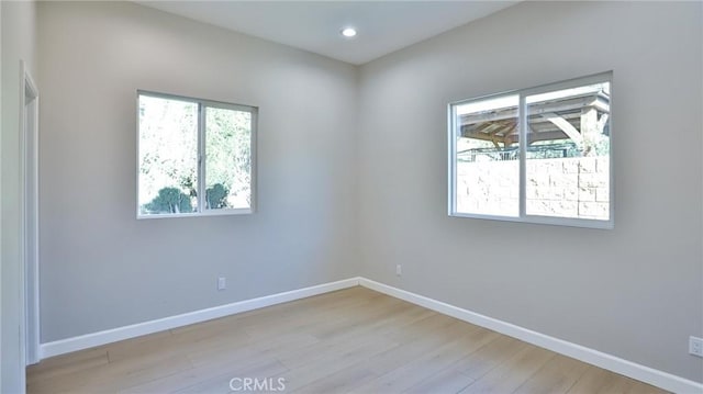 spare room featuring light hardwood / wood-style flooring