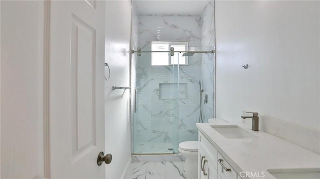 bathroom featuring vanity, a shower with shower door, and toilet