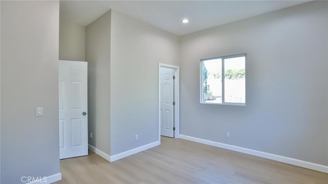 empty room with light hardwood / wood-style flooring