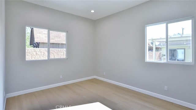 unfurnished room with hardwood / wood-style flooring