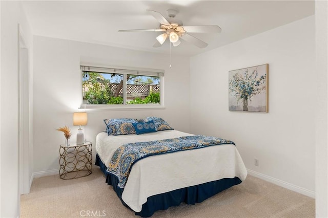 bedroom featuring light carpet and ceiling fan