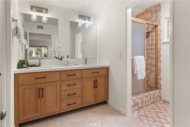 bathroom with vanity and a shower with shower door