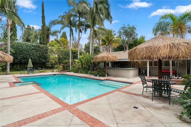 view of pool featuring an outdoor bar and a patio area