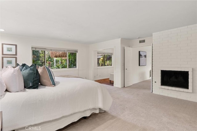 bedroom with carpet floors and a fireplace