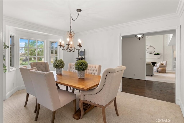 dining area featuring an inviting chandelier, hardwood / wood-style floors, and ornamental molding