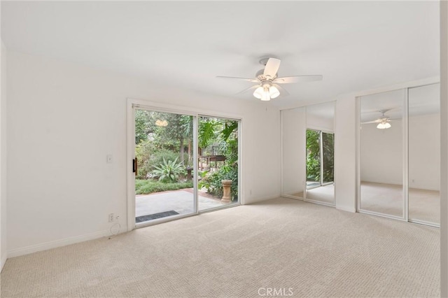 carpeted empty room with ceiling fan