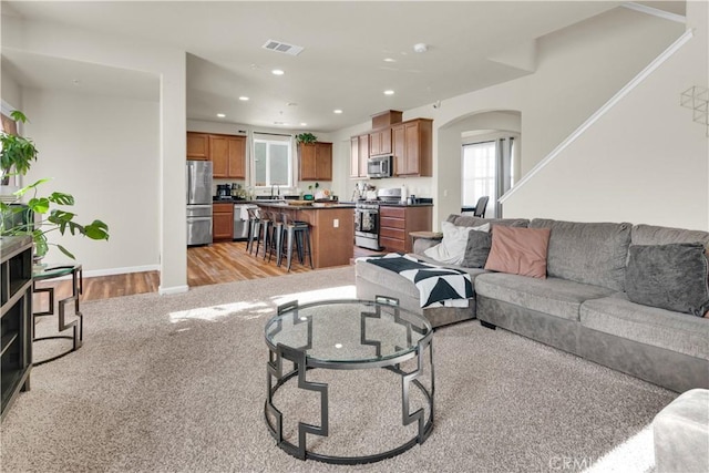 living room with sink and light wood-type flooring