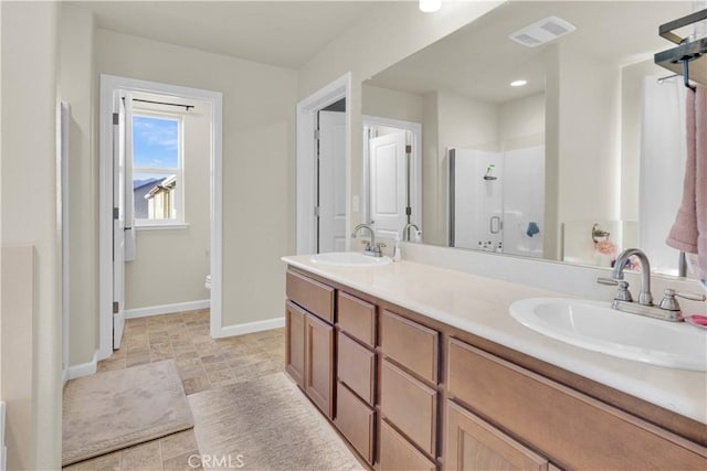 bathroom featuring vanity and a shower with shower door