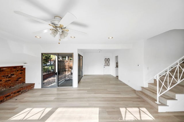 unfurnished living room featuring ceiling fan and light hardwood / wood-style flooring