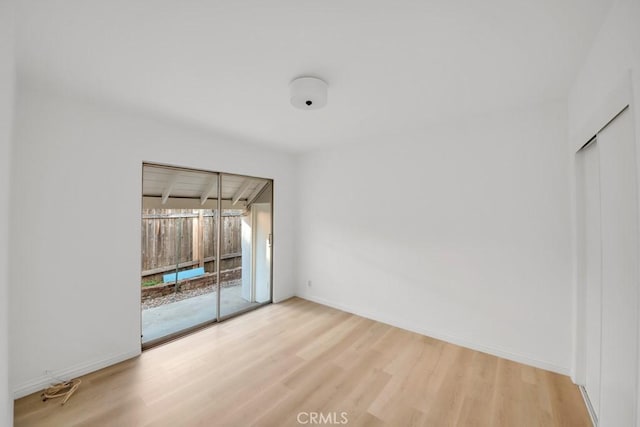 spare room featuring light wood-type flooring