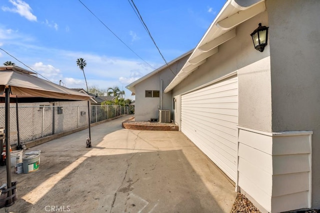 view of side of home with central AC, a patio area, and a gazebo