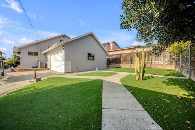 rear view of property with a yard and a patio area