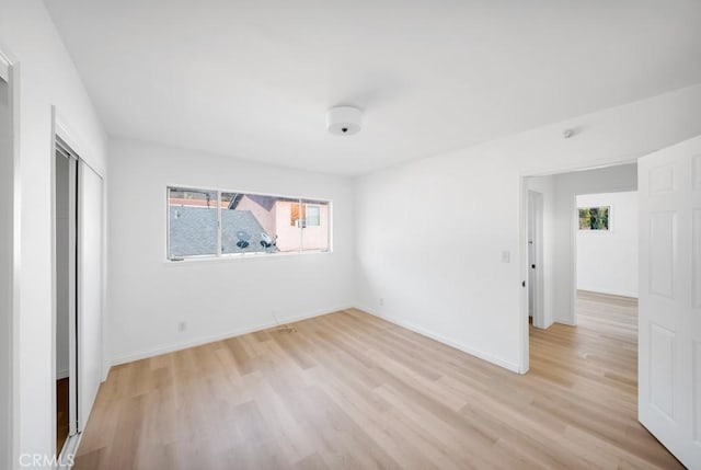 empty room with light hardwood / wood-style flooring