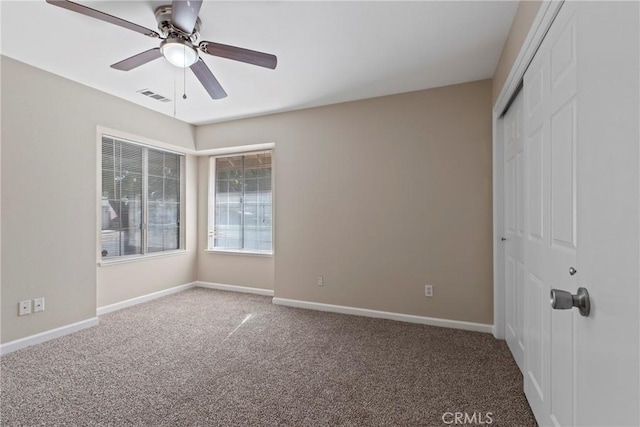 unfurnished bedroom with ceiling fan, carpet floors, and a closet