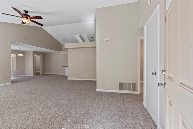 empty room with ceiling fan, lofted ceiling, and carpet floors