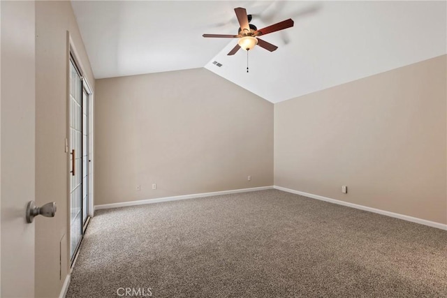 empty room with lofted ceiling, ceiling fan, and carpet