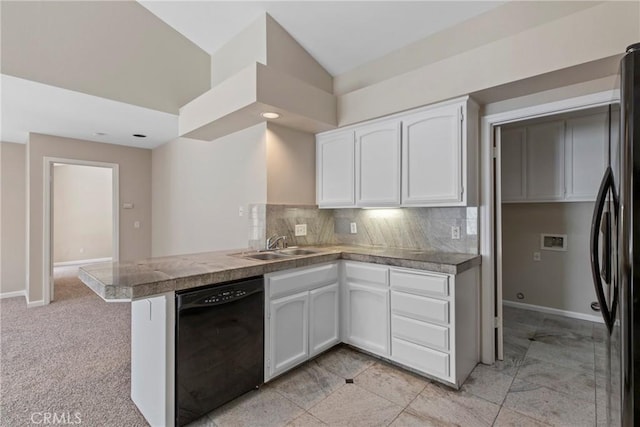 kitchen with white cabinetry, kitchen peninsula, backsplash, and black appliances