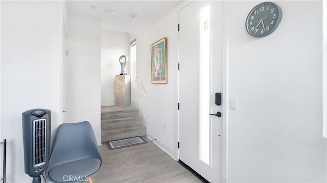 hallway with light hardwood / wood-style floors and heating unit