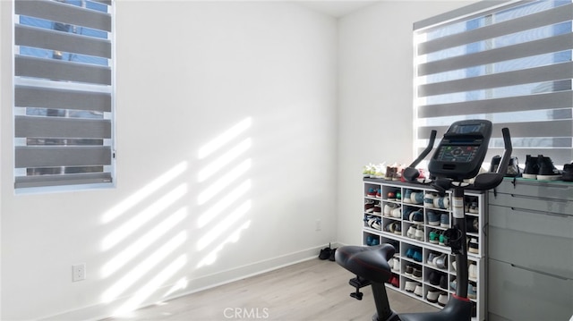 workout room with light hardwood / wood-style flooring