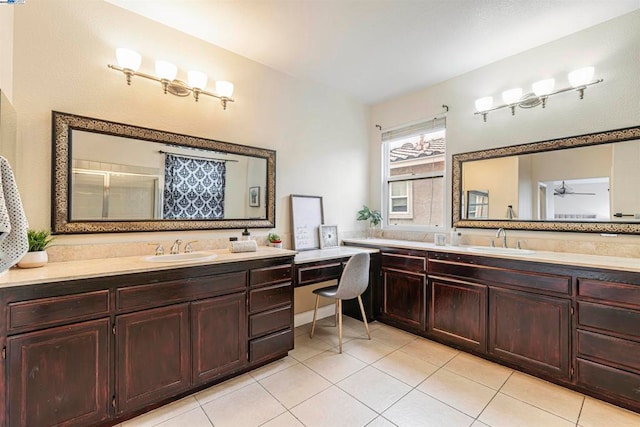 bathroom with tile patterned flooring, vanity, a shower with door, and ceiling fan