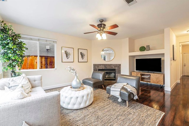 living room with ceiling fan, dark wood-type flooring, and a high end fireplace