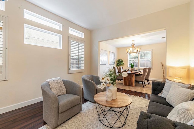 living room with a notable chandelier and light hardwood / wood-style floors