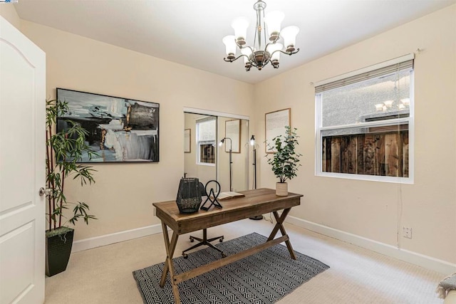 home office with light colored carpet and a notable chandelier