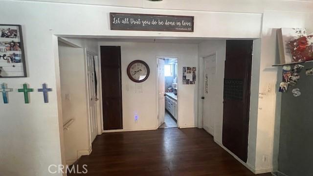 hallway with dark wood-type flooring