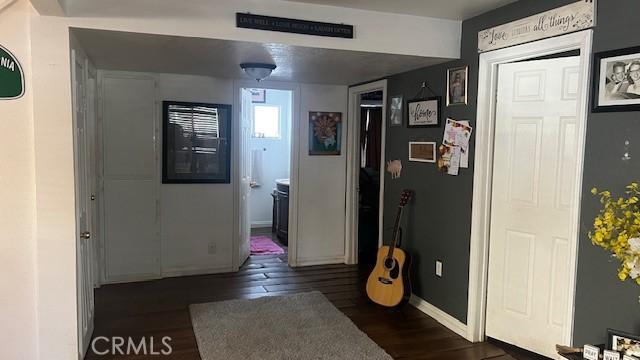 hall with dark hardwood / wood-style floors