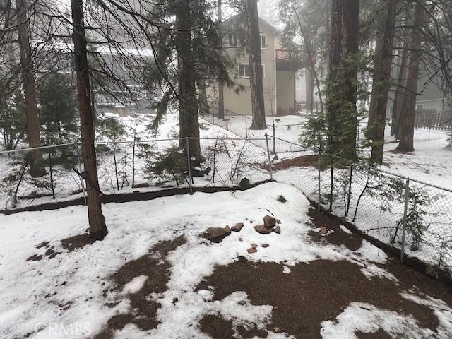 yard covered in snow with fence