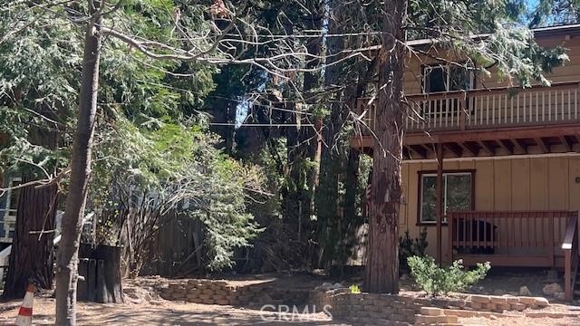 back of property featuring board and batten siding and a wooden deck