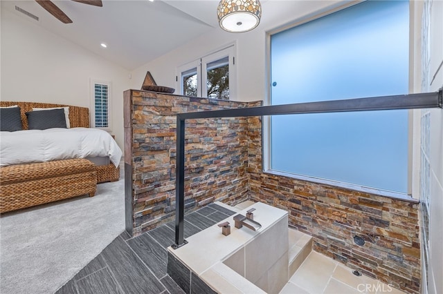 bathroom featuring ceiling fan and vaulted ceiling