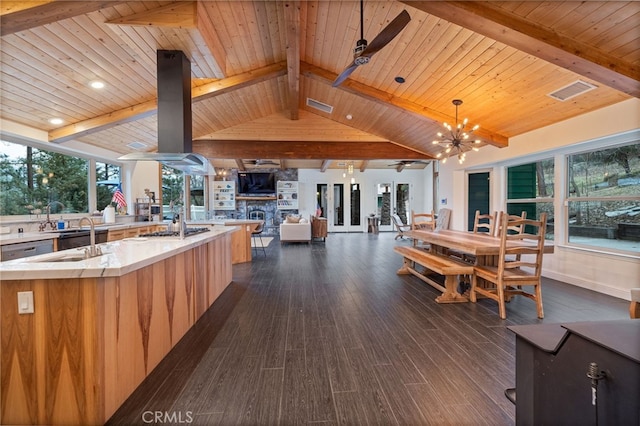 kitchen featuring a large island, vaulted ceiling with beams, island range hood, dark hardwood / wood-style flooring, and decorative light fixtures