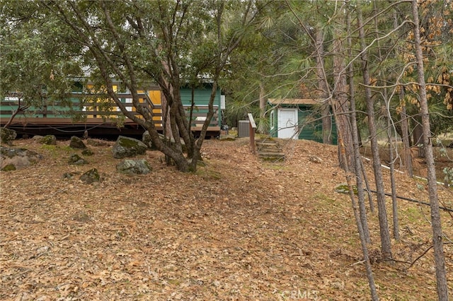 view of yard featuring cooling unit and a wooden deck