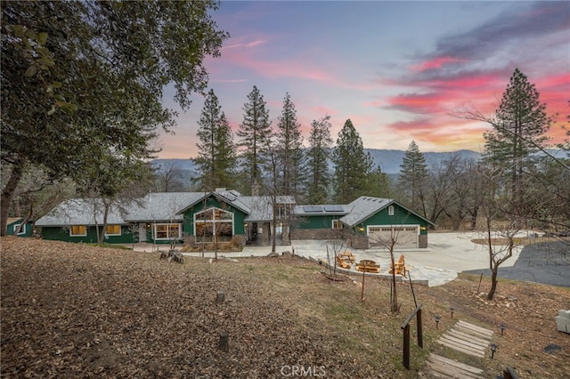 56207 Manzanita Lake Dr, North Fork, CA 93643 - exterior space with a mountain view, a garage, and solar panels