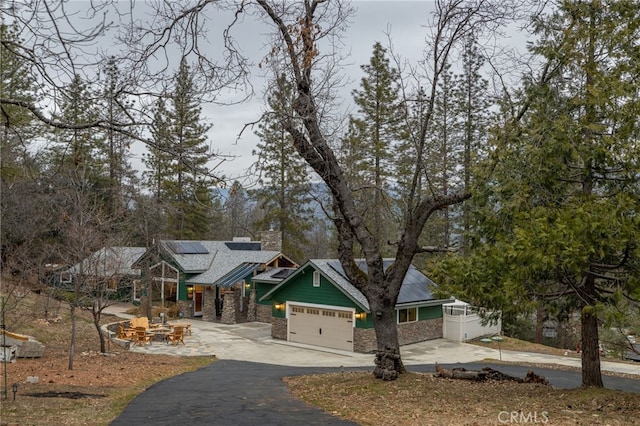 craftsman inspired home featuring a garage and solar panels