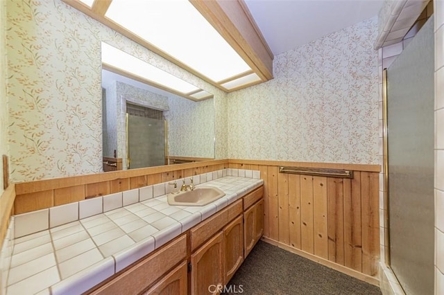 bathroom with an enclosed shower and vanity