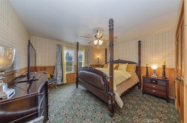 bedroom with ceiling fan and dark colored carpet