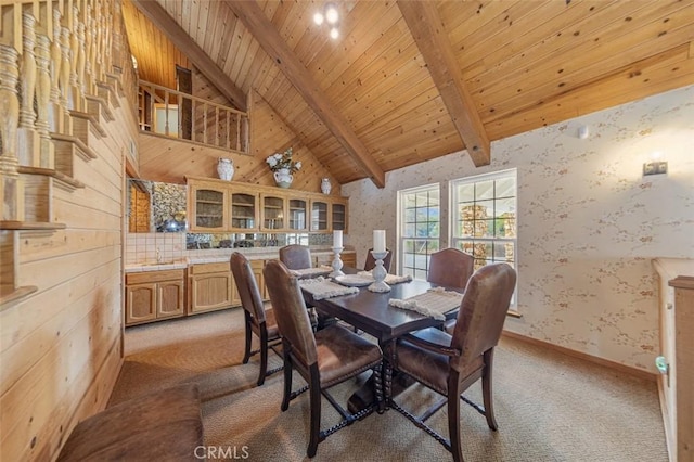 dining space with high vaulted ceiling, beamed ceiling, carpet flooring, and wooden ceiling